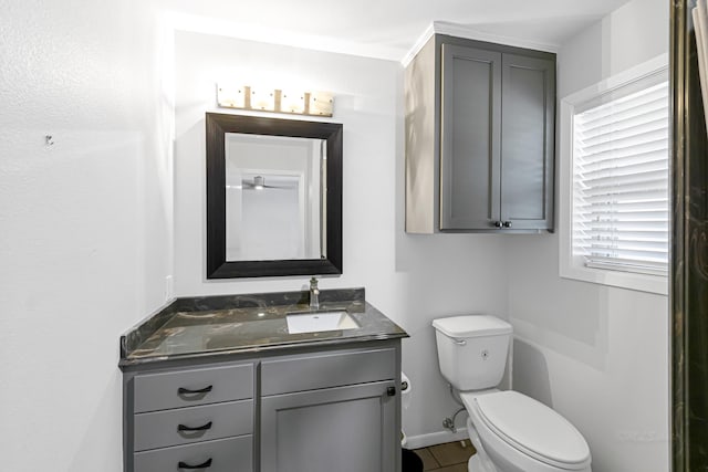 bathroom featuring tile patterned flooring, vanity, and toilet