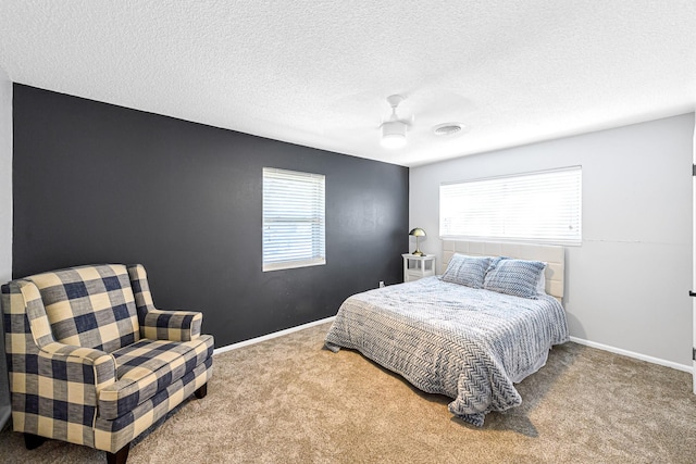 bedroom with carpet, a textured ceiling, and ceiling fan