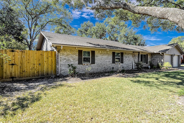 ranch-style home with a garage and a front lawn