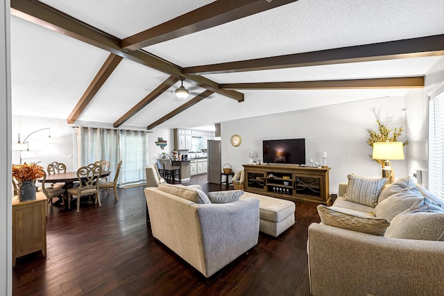 living room with a textured ceiling, vaulted ceiling with beams, ceiling fan, and dark wood-type flooring