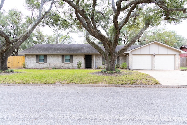 single story home featuring a front yard and a garage