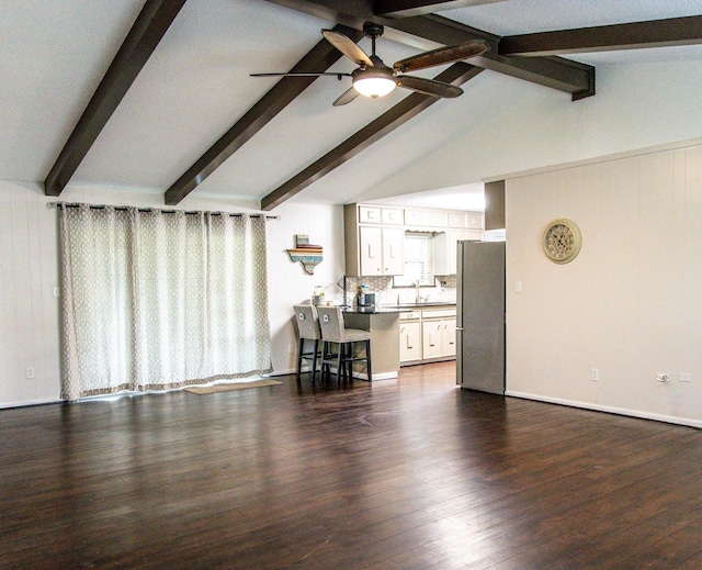 living room featuring vaulted ceiling with beams, ceiling fan, sink, and dark hardwood / wood-style floors