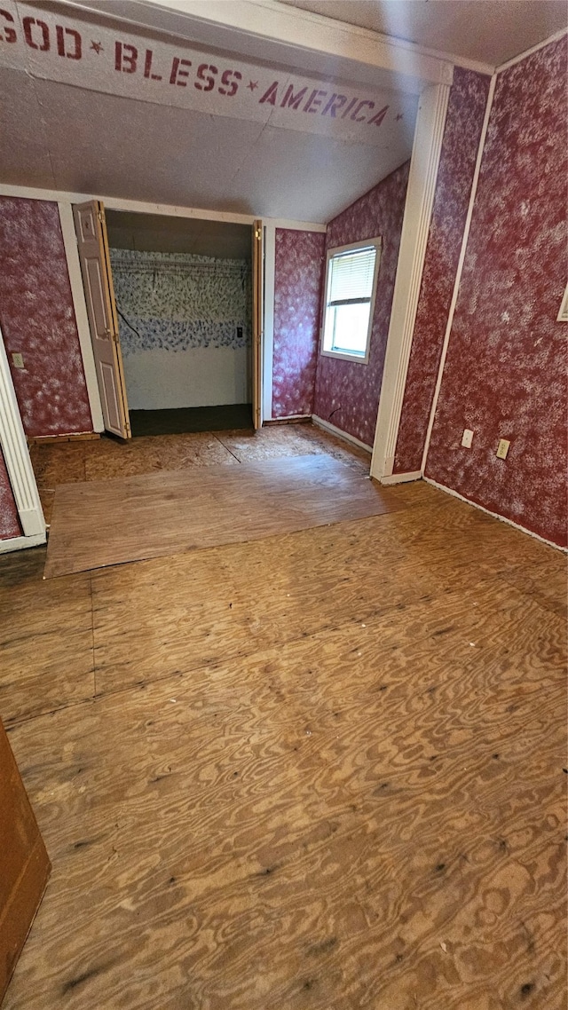 spare room featuring vaulted ceiling