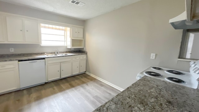 kitchen featuring white appliances, sink, light hardwood / wood-style floors, and white cabinets