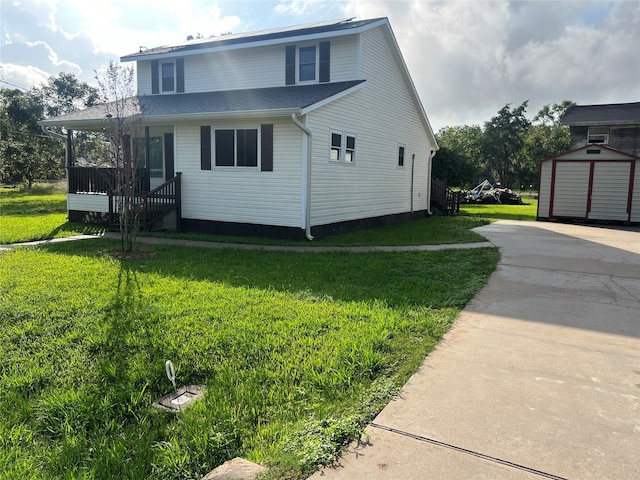 view of property exterior featuring a shed, a lawn, and covered porch