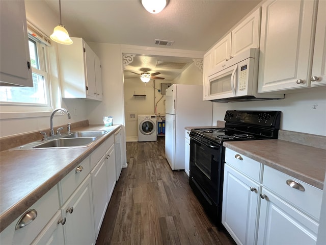 kitchen featuring dark wood-type flooring, white cabinets, black range oven, hanging light fixtures, and sink