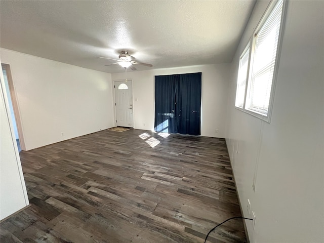 entryway with ceiling fan, dark hardwood / wood-style floors, and a textured ceiling