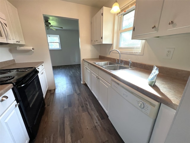 kitchen featuring white dishwasher, plenty of natural light, black range with electric cooktop, dark hardwood / wood-style floors, and white cabinetry