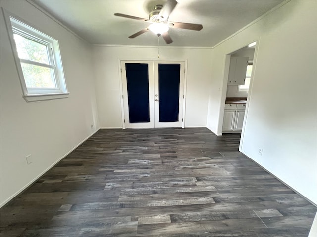 spare room featuring french doors, dark wood-type flooring, ceiling fan, and crown molding