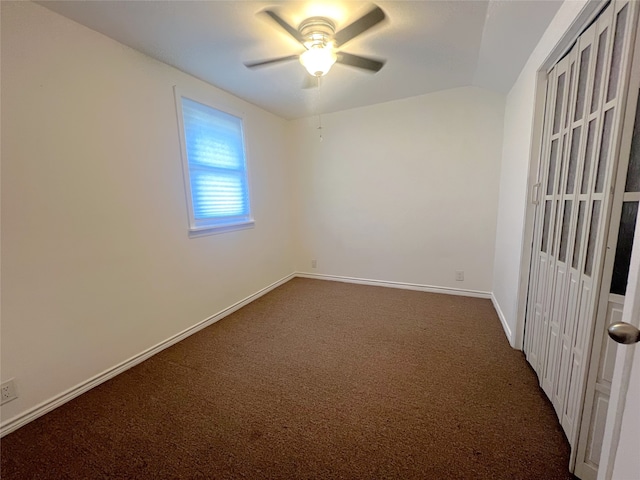 unfurnished room with dark colored carpet and ceiling fan