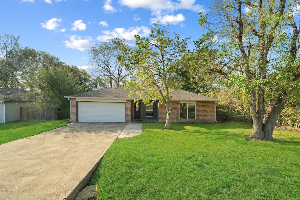 ranch-style home featuring a garage and a front yard