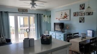 living room with ornamental molding and ceiling fan