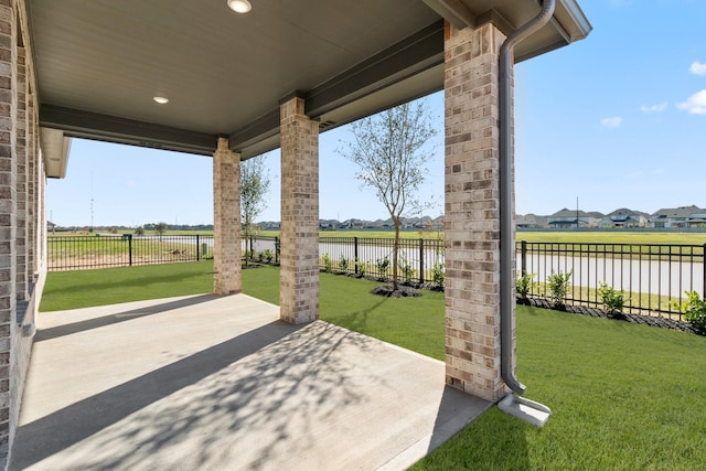 view of patio featuring a water view