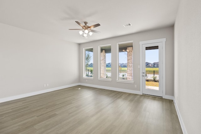 unfurnished room featuring wood-type flooring and ceiling fan