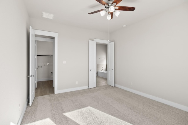 unfurnished bedroom featuring ceiling fan and light colored carpet