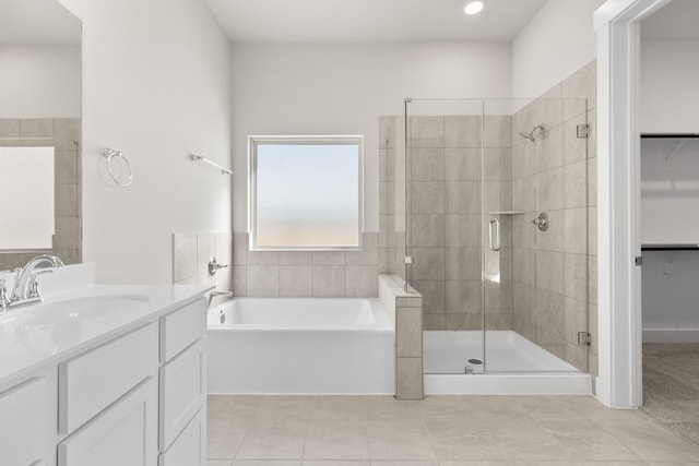 bathroom featuring tile patterned flooring, vanity, and separate shower and tub