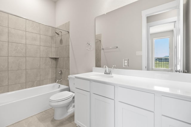 full bathroom featuring tile patterned flooring, toilet, vanity, and tiled shower / bath