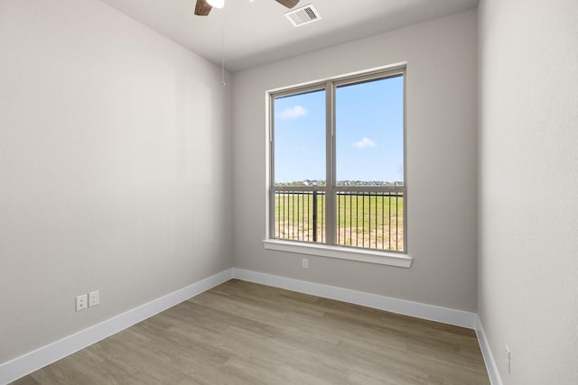 empty room featuring ceiling fan and light hardwood / wood-style floors