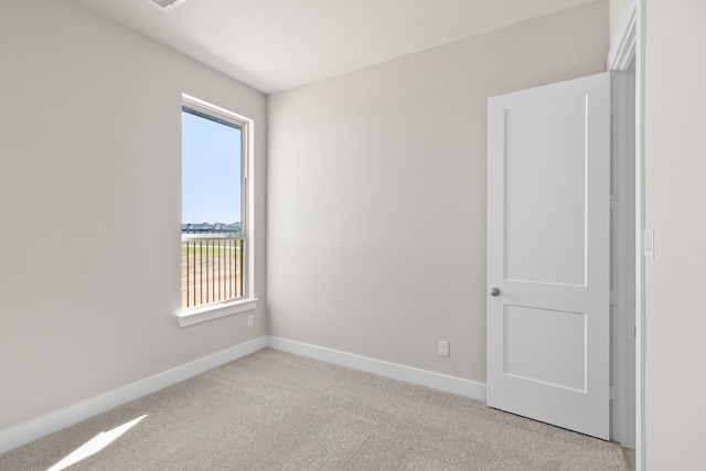 unfurnished room with light carpet