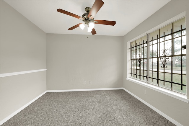 carpeted spare room featuring ceiling fan