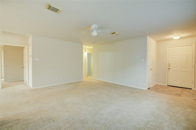 carpeted empty room featuring ceiling fan