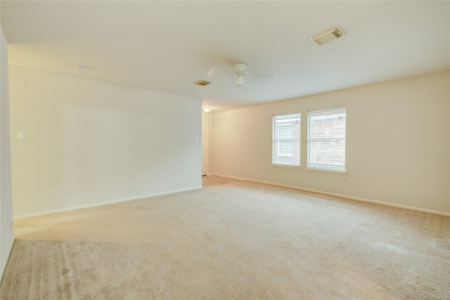 empty room featuring light carpet and ceiling fan