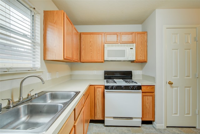 kitchen featuring sink and white appliances