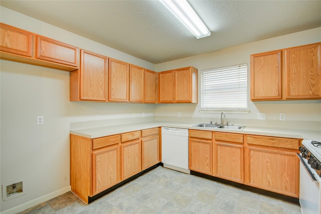 kitchen featuring a textured ceiling, sink, and white appliances