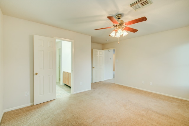 unfurnished room featuring light carpet and ceiling fan