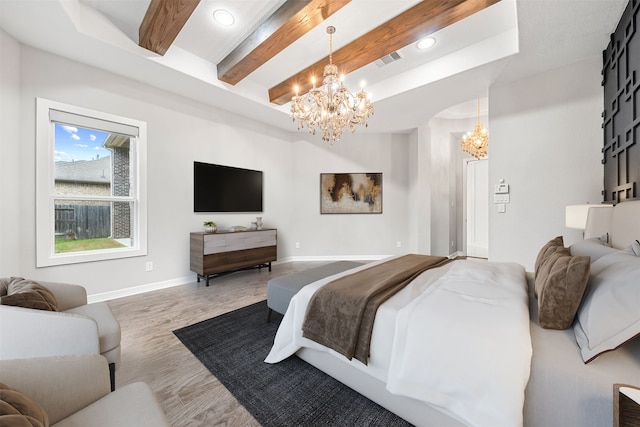 bedroom with beamed ceiling, wood-type flooring, and a notable chandelier