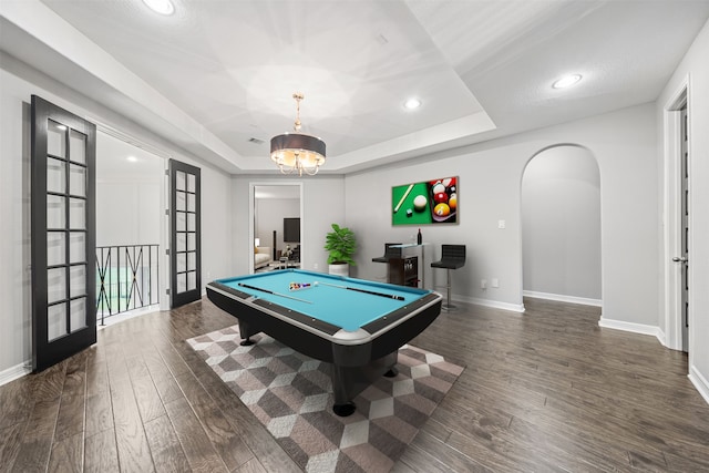 playroom with dark wood-type flooring, pool table, french doors, and a raised ceiling