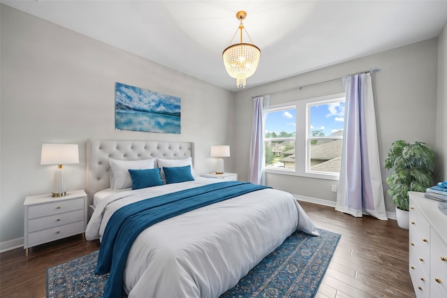 bedroom with dark hardwood / wood-style floors and a chandelier