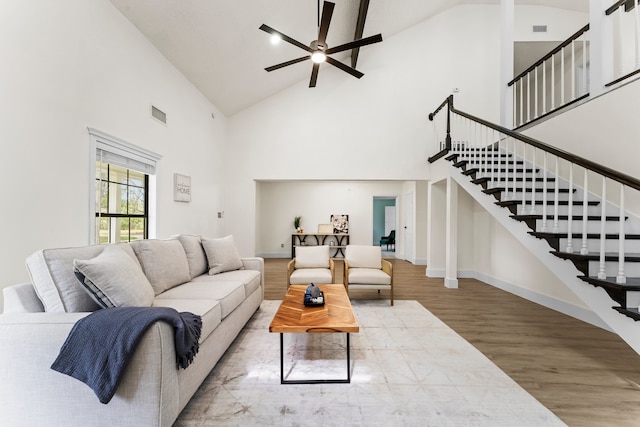 living room with ceiling fan, wood-type flooring, and high vaulted ceiling