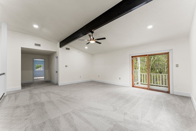 carpeted spare room with ceiling fan and lofted ceiling with beams