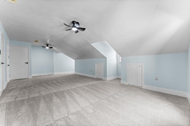 additional living space featuring vaulted ceiling, light carpet, and ceiling fan