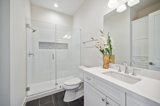 bathroom featuring tile patterned flooring, vanity, toilet, and a shower with door