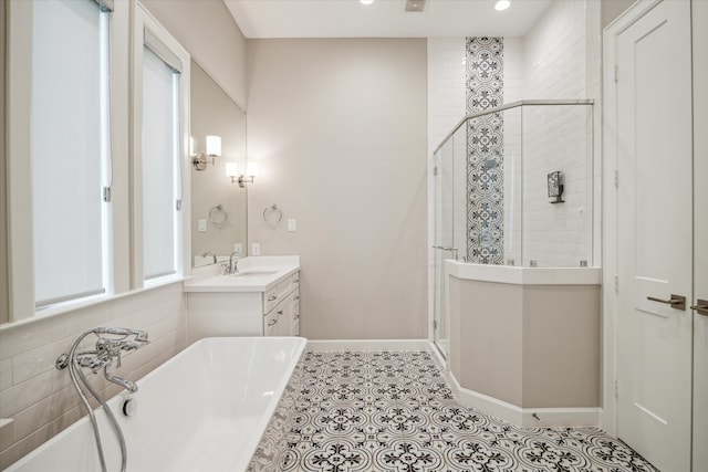 bathroom with independent shower and bath, vanity, and tile patterned floors