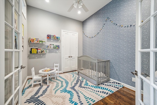 309 W Pierce St, Houston, TX 77019 - bedroom with french doors, baseboards, wood finished floors, recessed lighting, and a crib