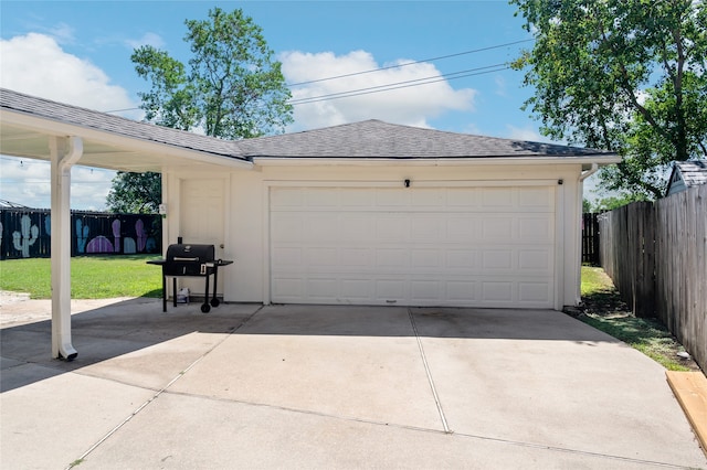 garage featuring a lawn