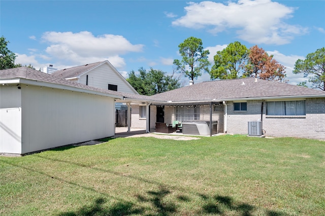 back of house featuring a patio, a lawn, and central air condition unit