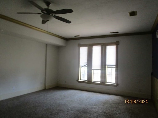 carpeted empty room featuring ceiling fan and crown molding