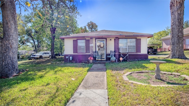 bungalow-style home with a front yard