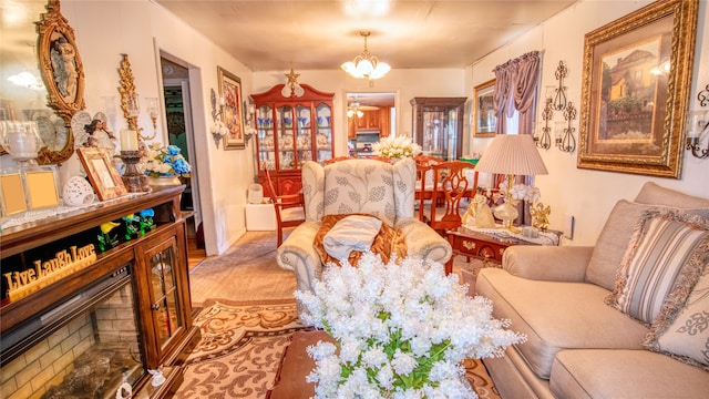 living area with ceiling fan with notable chandelier