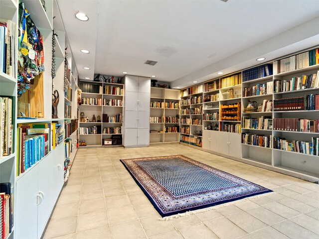 sitting room featuring built in features and light tile patterned floors