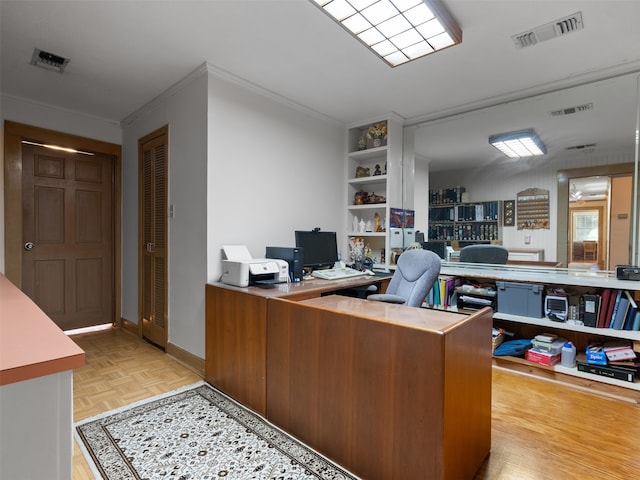 office area featuring light parquet floors and ornamental molding