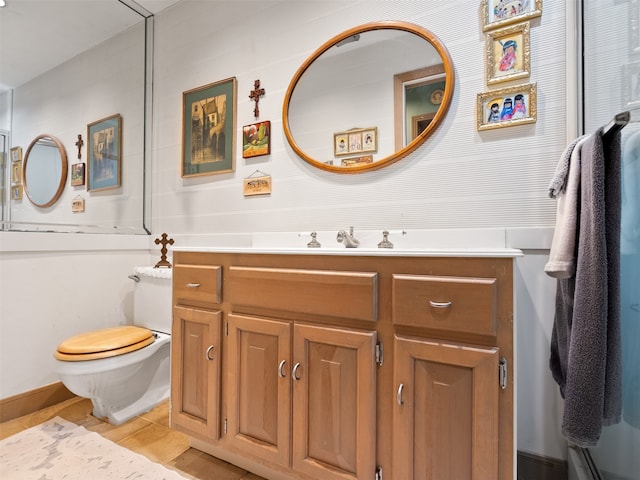 bathroom featuring tile patterned floors, vanity, and toilet