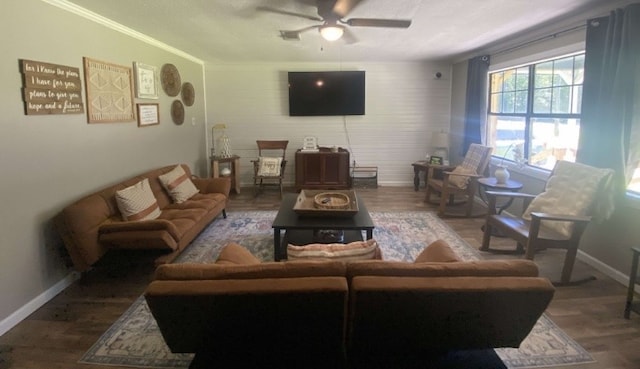 living room with hardwood / wood-style floors, ceiling fan, and crown molding