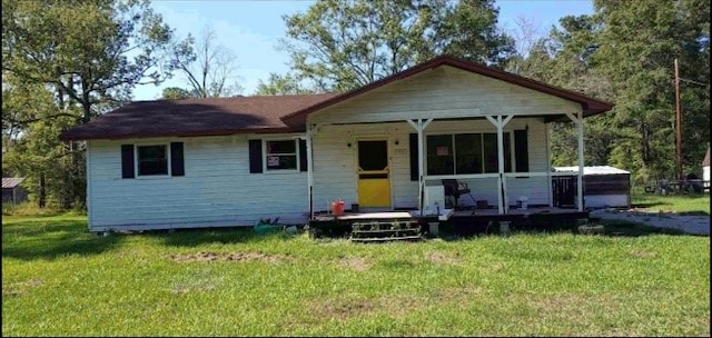 bungalow-style house featuring a front yard and covered porch