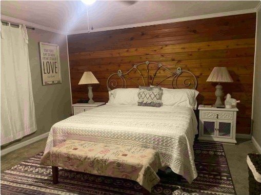 bedroom with wooden walls and crown molding