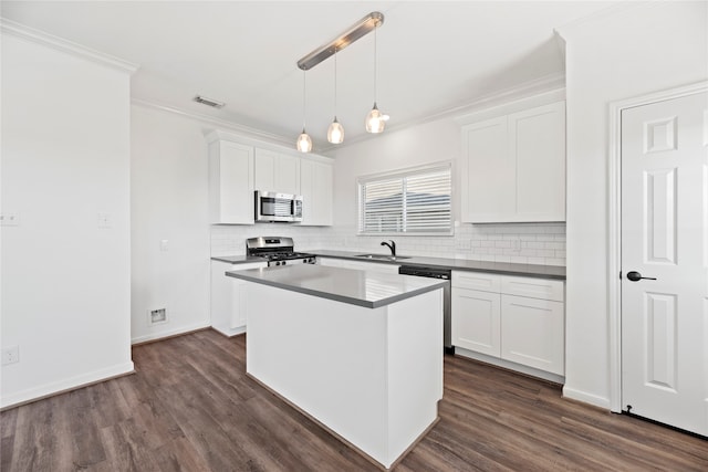 kitchen with dark wood-type flooring, white cabinetry, appliances with stainless steel finishes, and decorative light fixtures